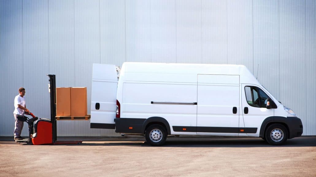 Man moving boxes into van